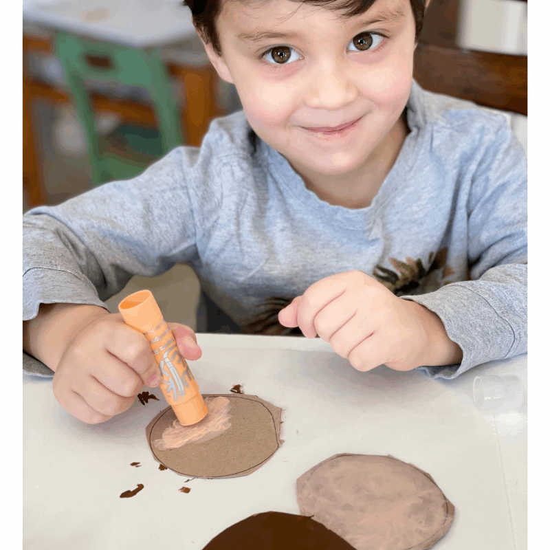 boy drawing with kwik stix global skin tones