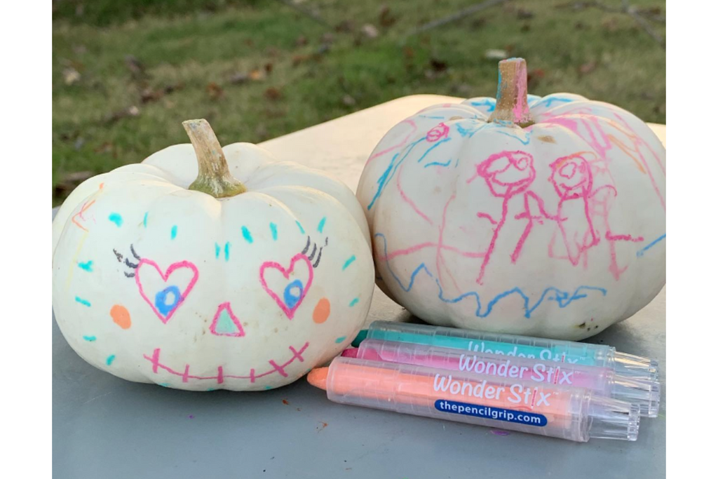 two decorated white pumpkins