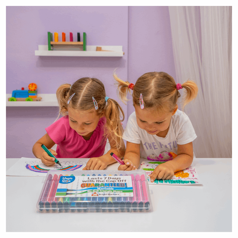 two girls drawing with magic stix markers