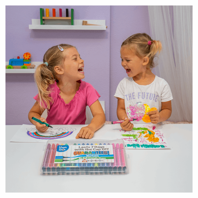 two girls laughing and drawing with magic stix markers