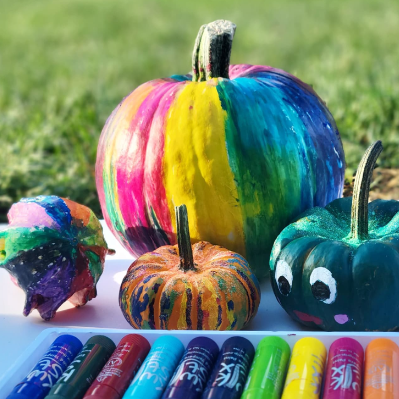 4 painted pumpkins in assorted colors