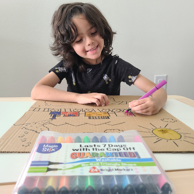 child drawing with magic stix